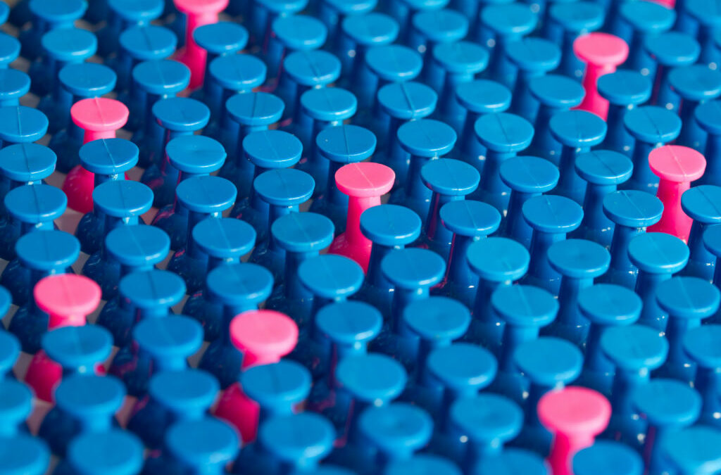 A few pink pins amongst many blue to support the idea what is process variation?