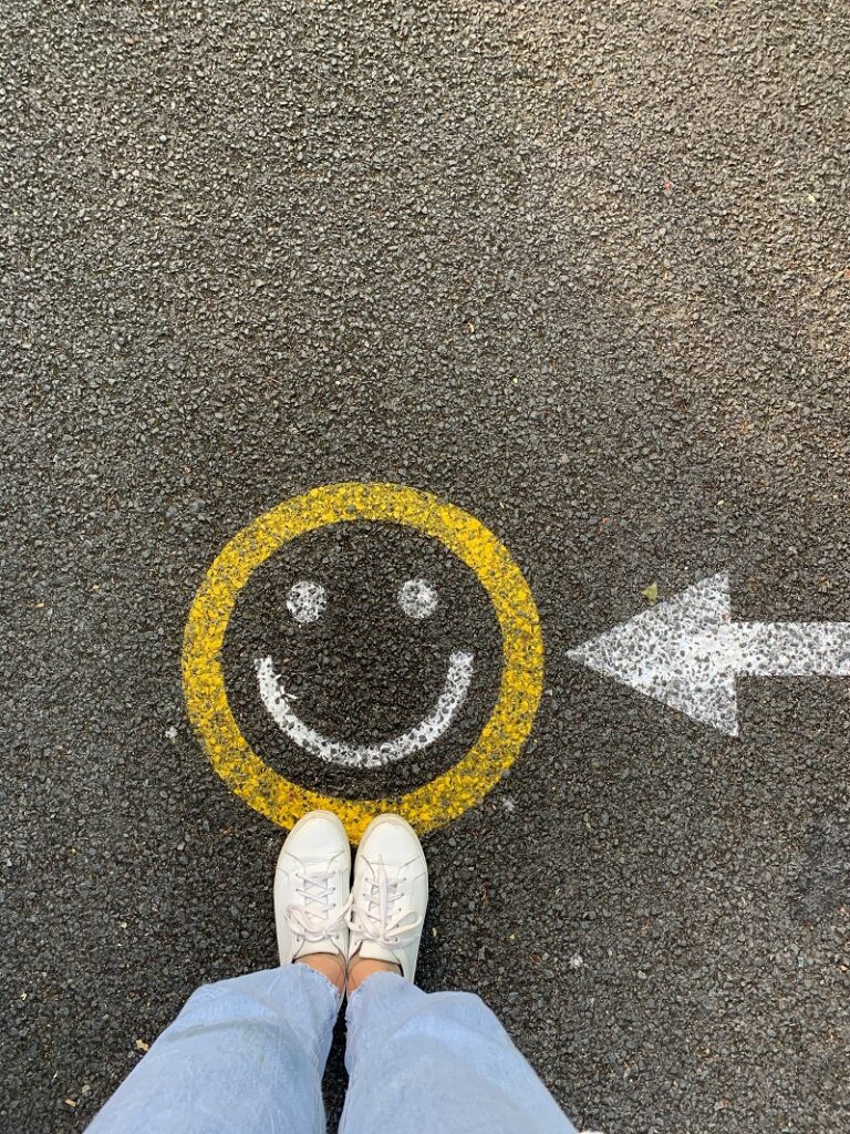 A smiley face painted onto a path
