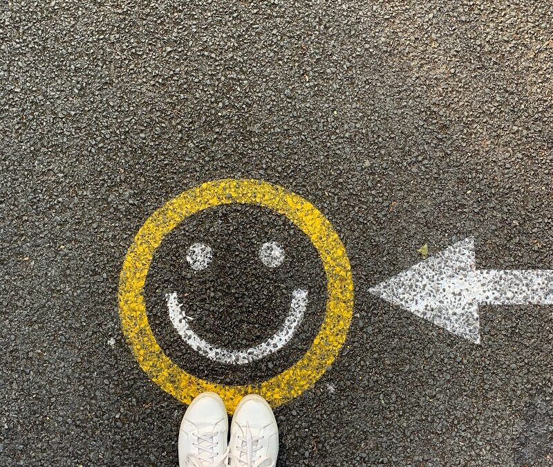 A smiley face painted onto a path